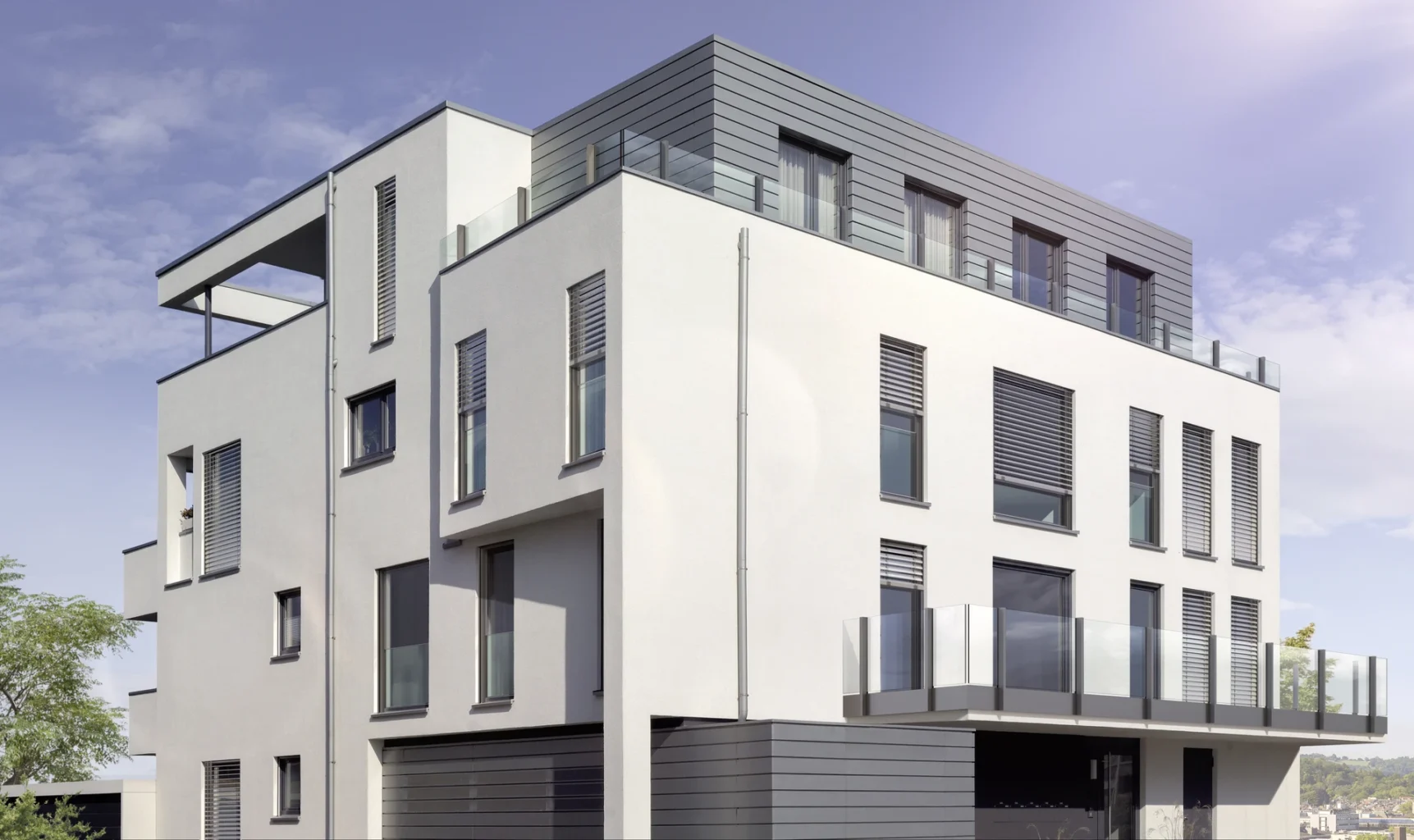 Moderne mehrstöckige Wohnanlage mit Glasbalkonen und grauen Fassadenelementen